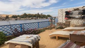 a patio with a view of a body of water at Hooly Nubian in Aswan