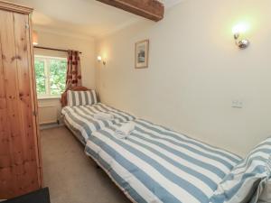 two twin beds in a room with a window at Byre Cottage 3 in Pulborough +38 photos