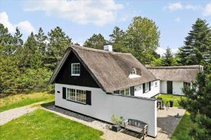 a white house with a black roof at 0194-Romo-Rabjergvej-76 in Høm