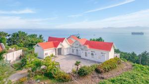 an aerial view of a house with red roofs at Namhae baramundeok Pension in Namhae