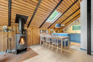 a kitchen and dining room with a wood stove at 0649-Toftlund-Ostmarken-49 in Toftlund