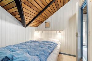 a large bed in a room with a wooden ceiling at 0649-Toftlund-Ostmarken-49 in Toftlund +28 photos