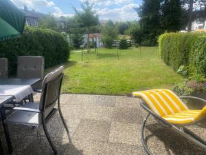 two chairs and a table on a patio with a yard at Ferienwohnung Fein in Bad Sachsa