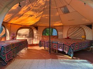 a tent with two beds inside of it at Glamping Tent Tammemäe in Haapsi
