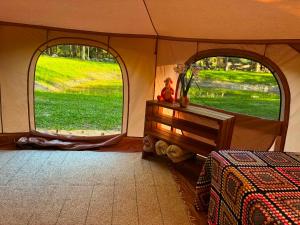 a room with two windows in a tent at Glamping Tent Tammemäe in Haapsi