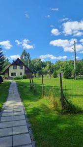a house in a field with a fence at Any Kulcsosház in Sicasău