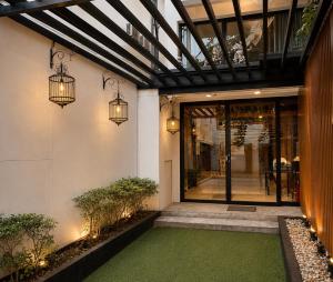 a front door of a building with a green floor at SaintLove Hotel in Chiang Mai