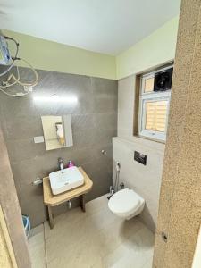 a bathroom with a toilet and a sink at Nestoria Corporate Services in Pune +37 photos