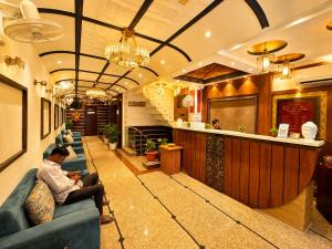 a lobby with couches and a bar in a restaurant at HOTEL LUXURY KASHI VISHWANATH- VARANASi in Varanasi