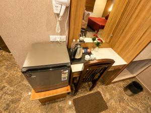 a small kitchen with a table and a counter top at HOTEL LUXURY KASHI VISHWANATH- VARANASi in Varanasi