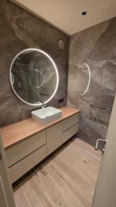 a bathroom with a sink and a mirror at Villa Jelena Rooms and Apartments in Kovačić +8 photos