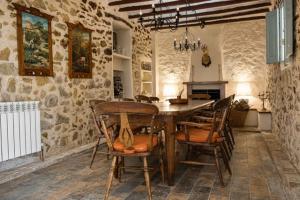 a dining room with a wooden table and chairs at Casa de la Suerte in Benissa