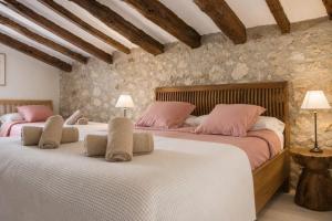 a bedroom with two beds with pink pillows at Casa de la Suerte in Benissa +18 photos