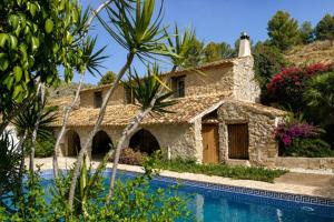 a house with a swimming pool next to a house at Casa de la Suerte in Benissa
