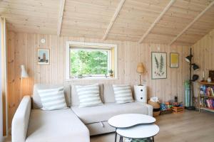 a living room with a white couch and a window at 11866-Nykobing-Sj-Skippervej-17 in Nyrup
