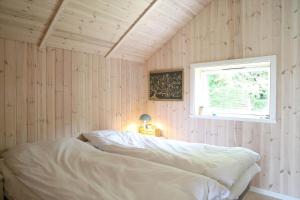 a bedroom with a bed in a room with a window at 11866-Nykobing-Sj-Skippervej-17 in Nyrup