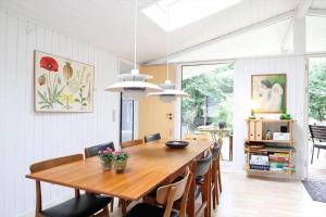 a dining room with a wooden table and chairs at 13373-Asnaes-Radyrvej-24 in Asnæs
