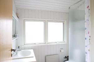 a bathroom with a sink and a toilet and a window at 13373-Asnaes-Radyrvej-24 in Asnæs +27 photos