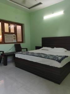 a bedroom with a large bed in a room at Friendly Guest House in Gorakhpur