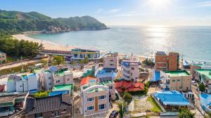 an aerial view of a town next to the ocean at Samcheok Eoulim Pension in Samcheok
