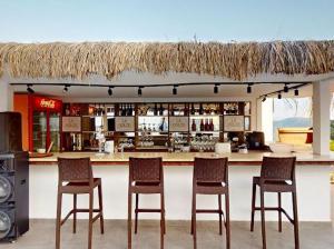 a bar with four chairs in front of a counter at Casa Mare Bodrum in Bodrum City
