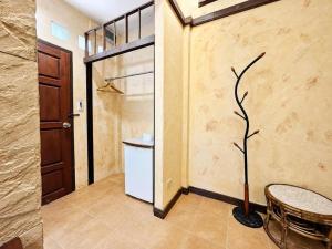 a room with a refrigerator and a table and a tree at Chalet De Palm Resort Hatyai in Hat Yai +17 photos