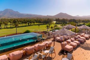 an aerial view of a resort with a pool and lounge chairs at Marylanza Suites & Spa in Playa de las Americas
