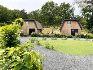 two barns with a lawn in front of a house at Park Heerehof Schoorl in Schoorl