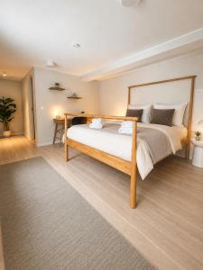 a bedroom with a large bed in a room at Modern Seaside Guesthouse with Archipelago Views in Nacka