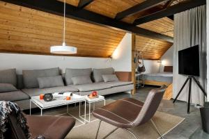 a living room with a couch and a tv at 530-Lemvig-Lokkevej-59-D in Lemvig