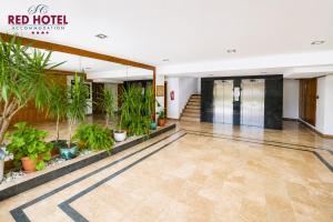 a lobby of a hotel with potted plants at Red Hotel Accommodation in Cluj-Napoca +102 photos