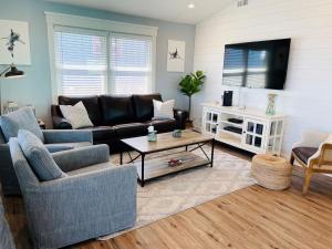 a living room with a couch and a tv at 3 4 Time in Holden Beach