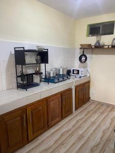 a kitchen with wooden cabinets and a counter top at LANISCA'S Home in Yaoundé +9 photos