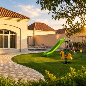 a playground in a yard with a slide at moon havena مون هافينا in Dhahran