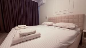 a bedroom with two white towels on a bed at Apartment OneClickRent 16 in Chişinău
