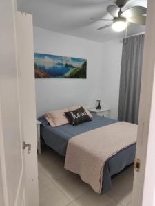 a bedroom with a bed and a ceiling fan at Marys Place in Costa Del Silencio +42 photos