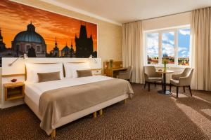 a hotel room with a bed and a large window at Metropolitan Old Town Hotel - Czech Leading Hotels in Prague