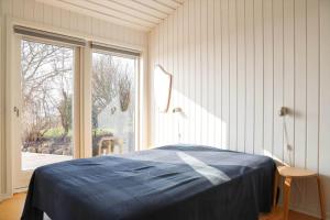 a bedroom with a bed and a large window at 14234-Grevinge-Strandmosen-11 in Grevinge