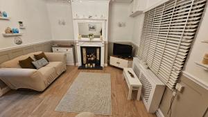 a living room with a couch and a fireplace at Twisted Chimney View in Alford
