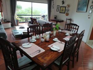 a wooden table with chairs and a dining room at Serenity Place B&B and Conference, wedding venue in Durban