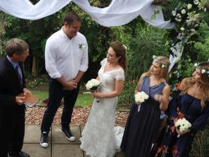 a bride and groom standing in front of a ceremony at Serenity Place B&B and Conference, wedding venue in Durban +39 photos