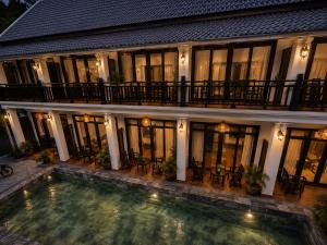 a house with a swimming pool in front of it at Luang Prabang Indochine Heritage Hotel in Luang Prabang +30 photos