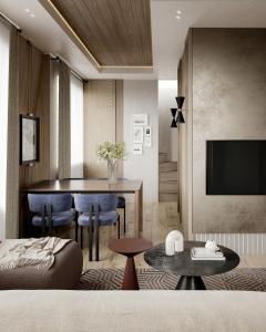 a living room with a table and a television at West Hill Apart Hotel in Kopaonik