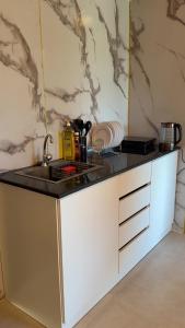 a kitchen with a counter top with a sink at Wadi Bani Khalid Oasis in Dawwah