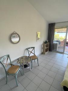 a room with two chairs and a table and a table at Seaview 180 in Skala Fourkas