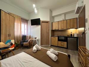 a bedroom with a bed with towels on it at Breeze Apartments Megara - Nest in Megara