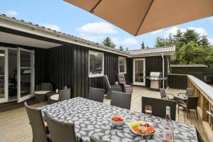 a patio with a table and chairs on a deck at LF16124-Farso-Bjarkesvej-4 in Farsø +26 photos