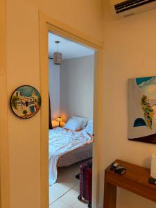 a bedroom with a bed and a door with a mirror at شمس in Hammamet Nord