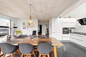 a dining room and kitchen with a table and chairs at 0431-Romo-Vestergade-333 in Høm
