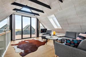 a living room with a couch and a table at 0431-Romo-Vestergade-333 in Høm